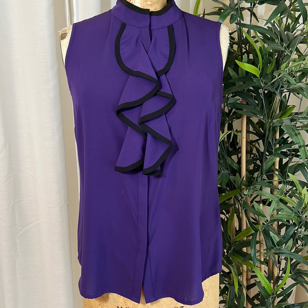 Sleeveless, high collar blouse with ruffle detail